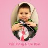 Young child smiling while holding a copy of Pink Patsy and the Moon.