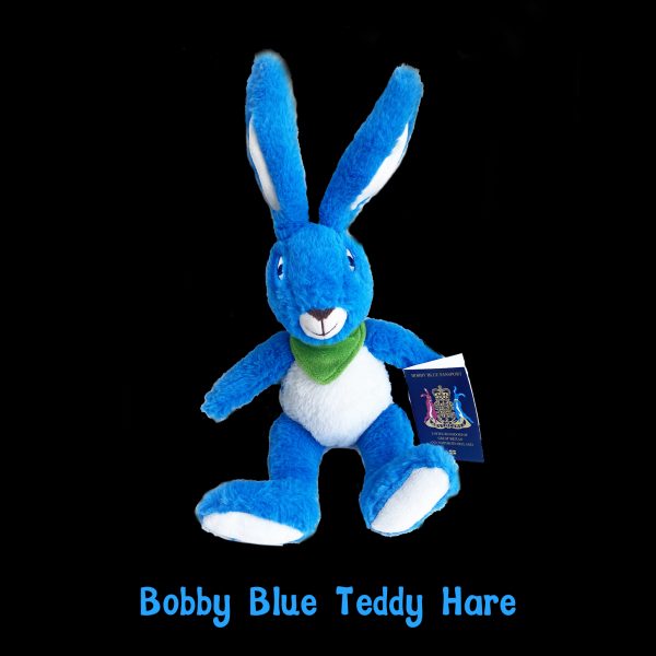 Bobby Blue Teddy Hare: soft blue and white plush hare with a green scarf, holding his Bobby Blue passport