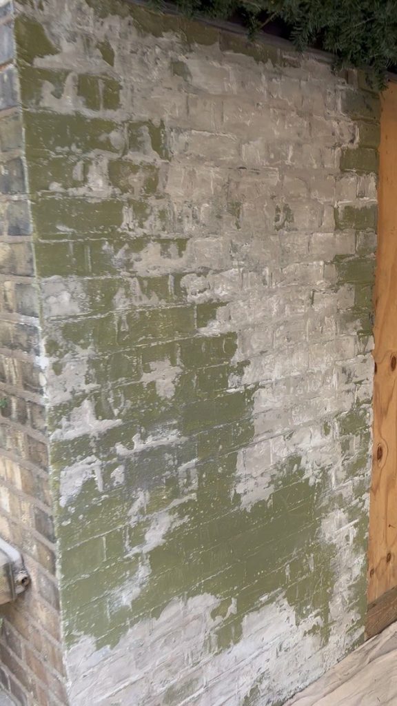 The bare, mossy brick wall at the Crocodile Café in Muswell Hill before the Pink Patsy mural was painted