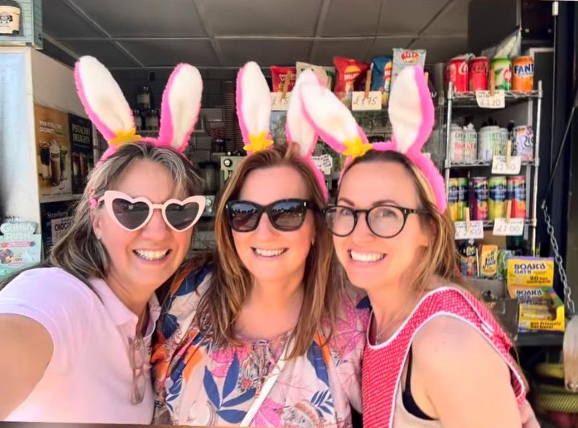 The Magmay Books team smiling together in fluffy pink and white Pink Patsy bunny ears