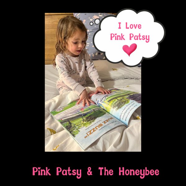 Young child reading Pink Patsy and the Honeybee in bed, with the words I Love Pink Patsy