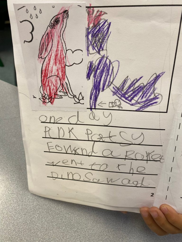 A child’s Pink Patsy story page: one day Pink Patsy found a rocket and went to the dinosaur age, with a crayon dinosaur drawing