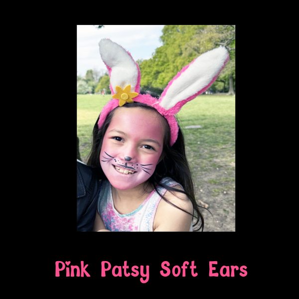 Pink Patsy Soft Ears worn with bunny face paint Smiling child wearing Pink Patsy Soft Ears with pink bunny face paint in the park