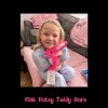 Smiling girl hugging her new Pink Patsy Teddy Hare at home