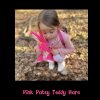 Little girl cuddling the Pink Patsy Teddy Hare on a walk through autumn leaves