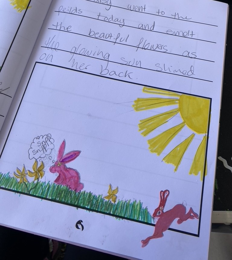 A child’s adventure journal page about Pink Patsy smelling the flowers in the sunshine, with a colourful drawing